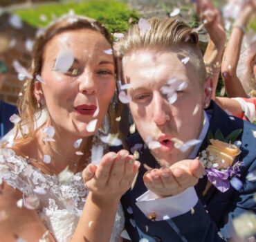 Bride and Groom Blowing Confetti